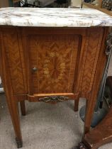 A marble top cabinet the single door inlaid above