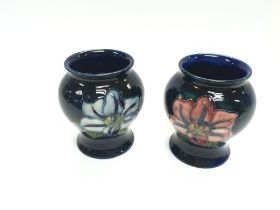 Two small Moorcroft vases both 8cm tall. The left