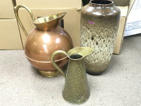 A large copper and brass jug, (40cm tall) a German vase (45cm tall) and another jug. No reserve