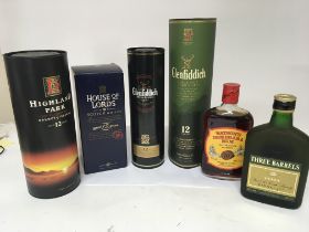 A collection of 12 year Highland Scotch Whisky 700cl bottles a bottle of rum and Three Barrels