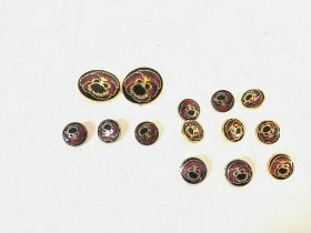 A set of enamelled buttons. Two larger ones are 25