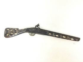 A Flint Lock Pistol inlaid with mother of pearl. 5