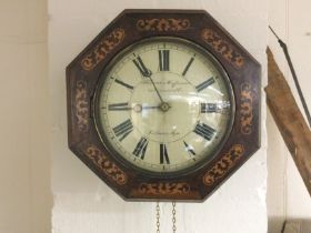 A drop dial inlaid octagonal wall clock with weights and pendulum. Shipping category D.