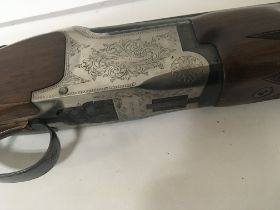 A 12bore Miroku shotgun with engraved action 26inch barrel over and under.with barrel selector.