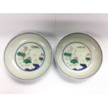 A pair of Oriental dishes decorated with cranes in