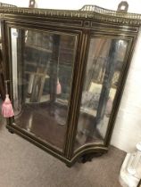 A Regency style hanging cabinet with raised brass