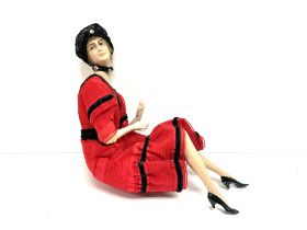 A 1920s style seated porcelain lady, 16cm x 16cm.