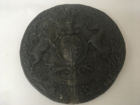 A lead wall plaque of circular shape with Royal co