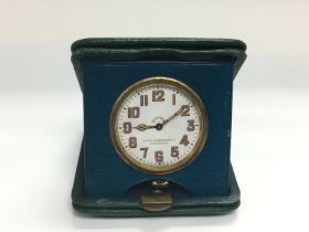 A vintage 8 day travelling clock. Shipping categor