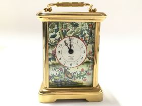 A small brass carriage Halcyon Days Enamels clock.