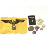 A collection of Third Reich badges including political badge, German State Service arm band and