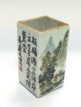 An Oriental brush pot of squared form decorated wi