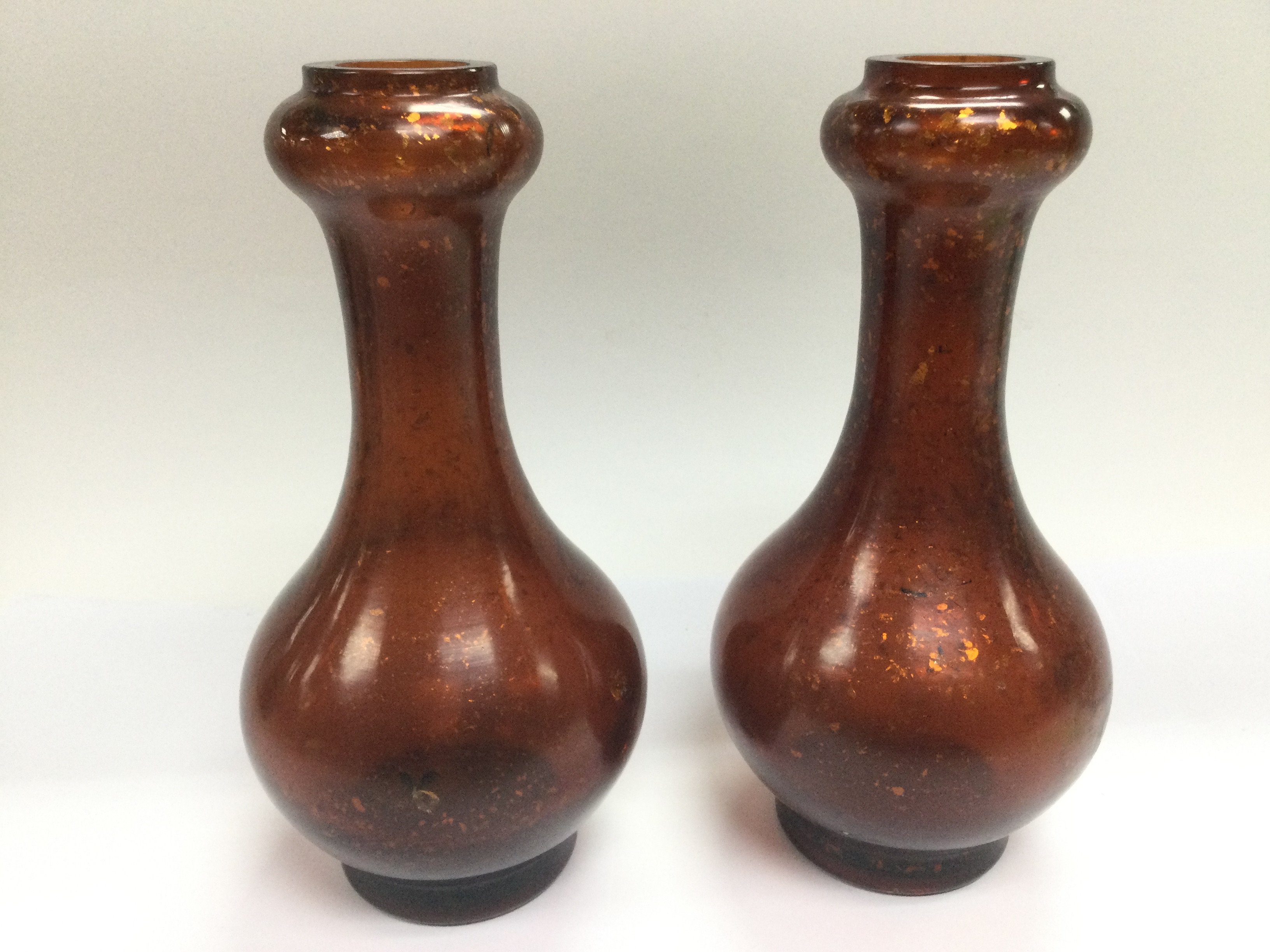 A pair of amber glass vases decorated with gold co