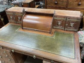 A large arts and crafts desk with green leather inset. 156 wide 96 deep 76cm high.