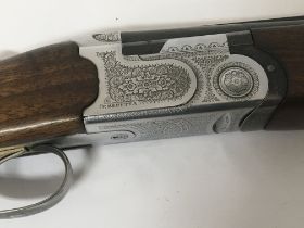 A Beretta 686 over and under shotgun with engraved