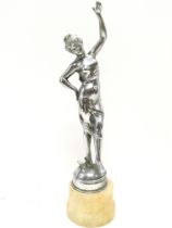 A chrome art deco figure of a dancing woman on an