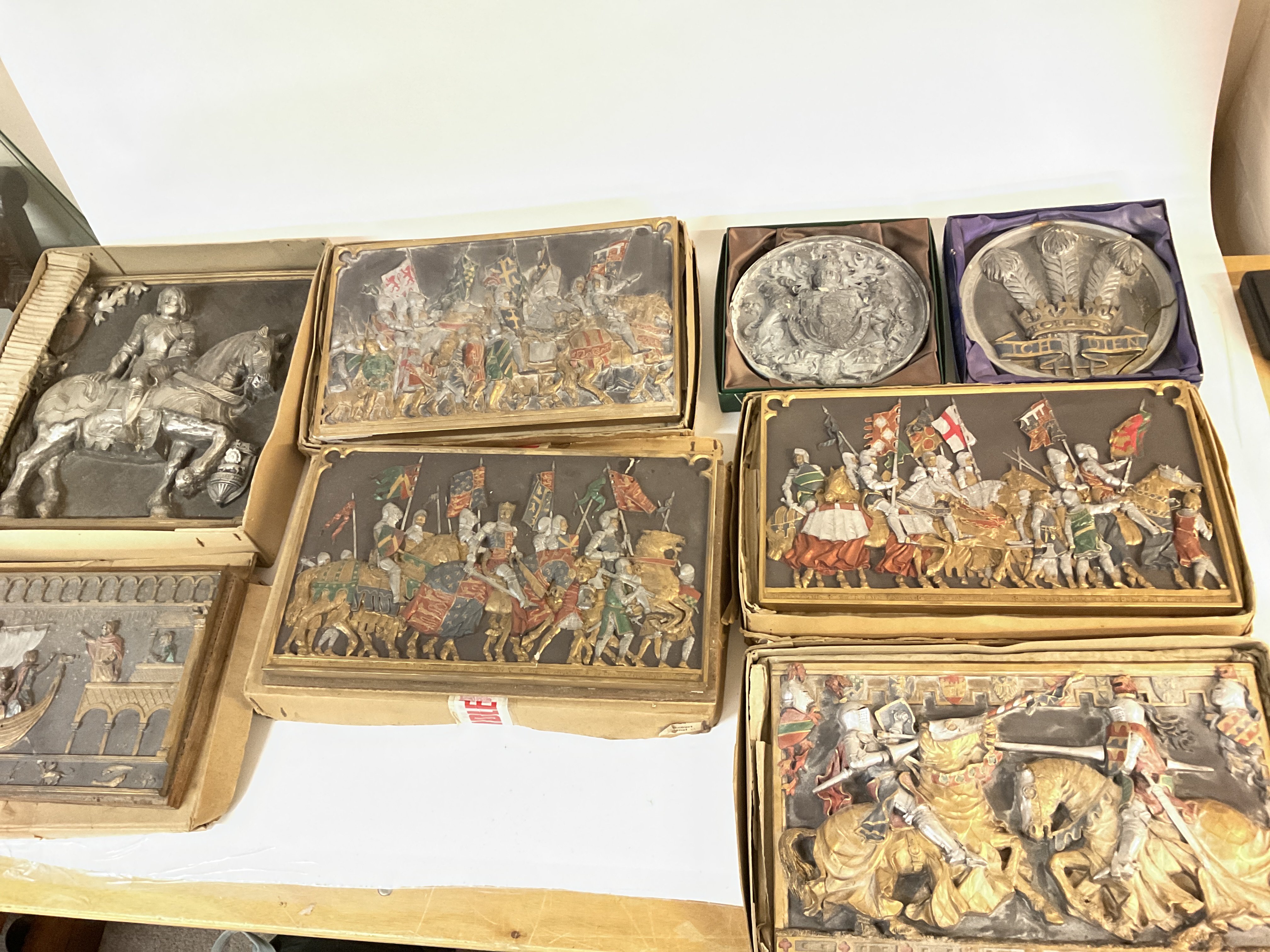 A collection of 8 vintage plaques including Marcus design knights jousting ones. Postage D