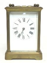 An enamelled face brass carriage clock. Dimensions