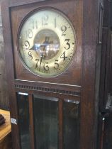 A oak long case 30 hour clock the circular dial wi