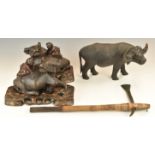 A pair of Chinese wooden carving of water buffalo with figures on their backs, on wooden bases,