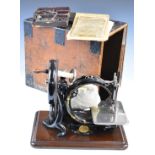 Late 19th or early 20thC Willcox & Gibbs sewing machine, in pine carry case with hinged handle to