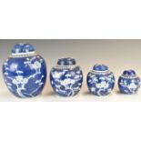 Chinese blue and white set of four graduated ginger jars with prunus decoration, tallest 19cm