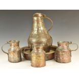 Collection of African tribal copperware including large dishes, covered jug etc, tallest 38cm