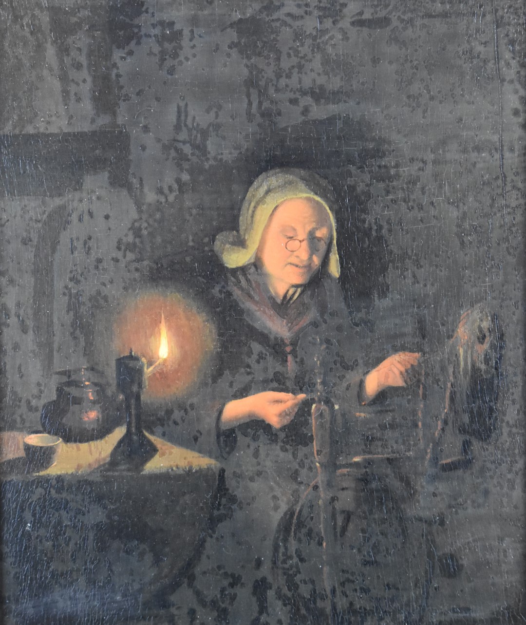 19thC continental oil on board spinning wool by candlelight, 29 x 24cm, in gilt frame