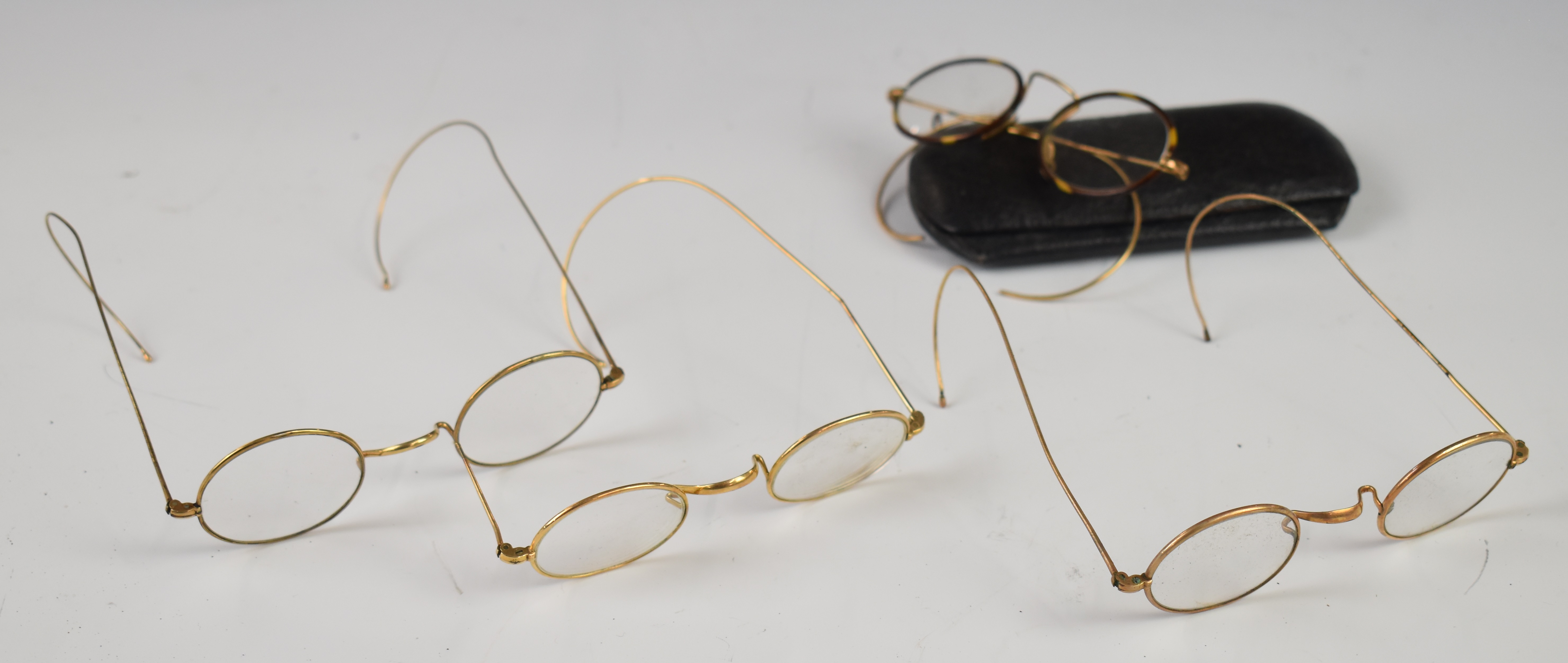 Four pairs of late 19th/ early 20thC vintage gold spectacles together with a Gloucester Co-Operative