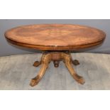 19thC inlaid walnut oval tilt top table raised on a carved base, W103 x D73 x H48cm