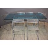 Designer glass dining table and six chairs with industrial gantry stretcher, raised on four circular