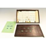 A bone and bamboo Mah Jong set, in wooden box with instructions