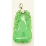 A carved jadeite pendant in the form of a pear and foliage, 7.3g, 3.5 x 1.8cm