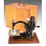 Late 19th or early 20thC Willcox & Gibbs sewing machine, in pine carry case with hinged handle to
