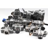 Eleven 35mm SLR cameras including Voigtlander Bessamatic with 1:2.8/50 and 1:4/135 lenses, Chinon