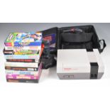 Nintendo Entertainment System NES with two controllers, Game Genie and 10 boxed games including