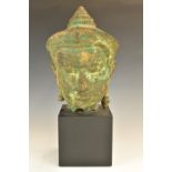 Archaic style cast metal bust on square plinth, possibly Thai or Burmese, height 46cm