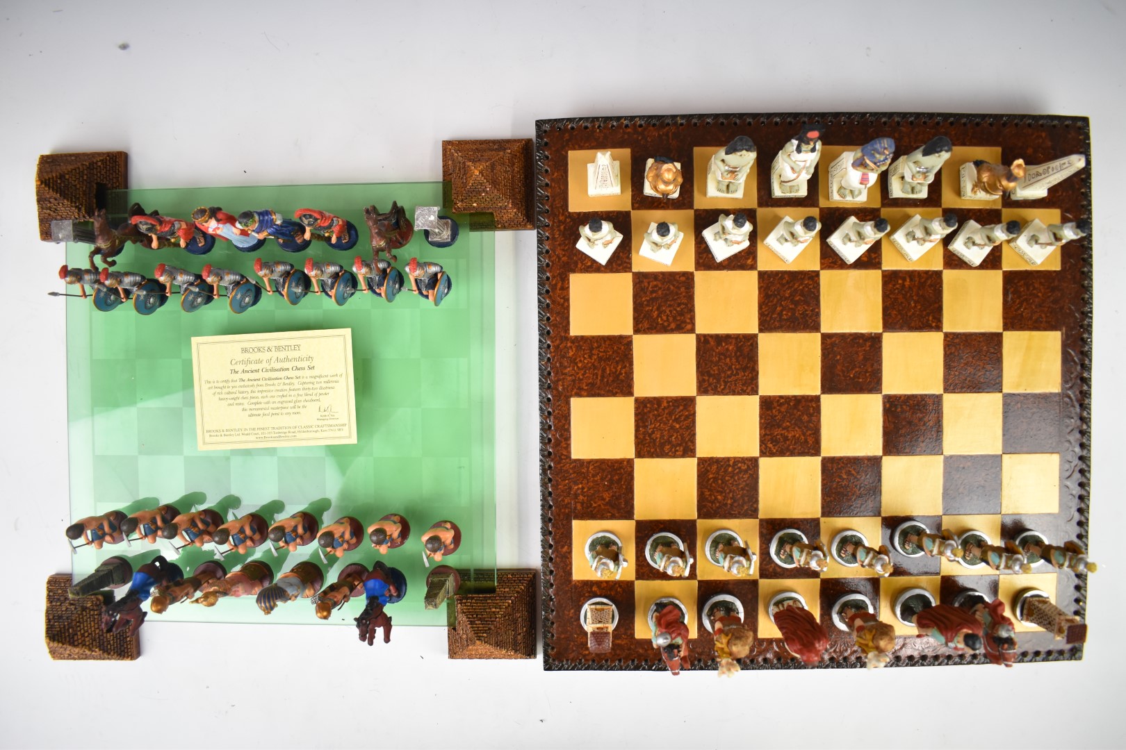 Two Brooks & Bentley chess sets with Egyptian and Roman figures, one with lead style pieces the