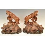 Two pairs of Chinese wooden carvings, one in the form of figures riding water buffalo, the other