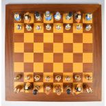 Studio Anne Carlton Alice in Wonderland chess set on wooden board, with related paperwork.