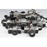 Seven 35mm SLR cameras comprising Canon A-1 program with 50mm 1:1.8 lens, Olympus OM20 body,