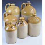 Six stoneware flagons including Shergold & Kimber, Gilletts Cirencester, Bateman Stroud, Mason's