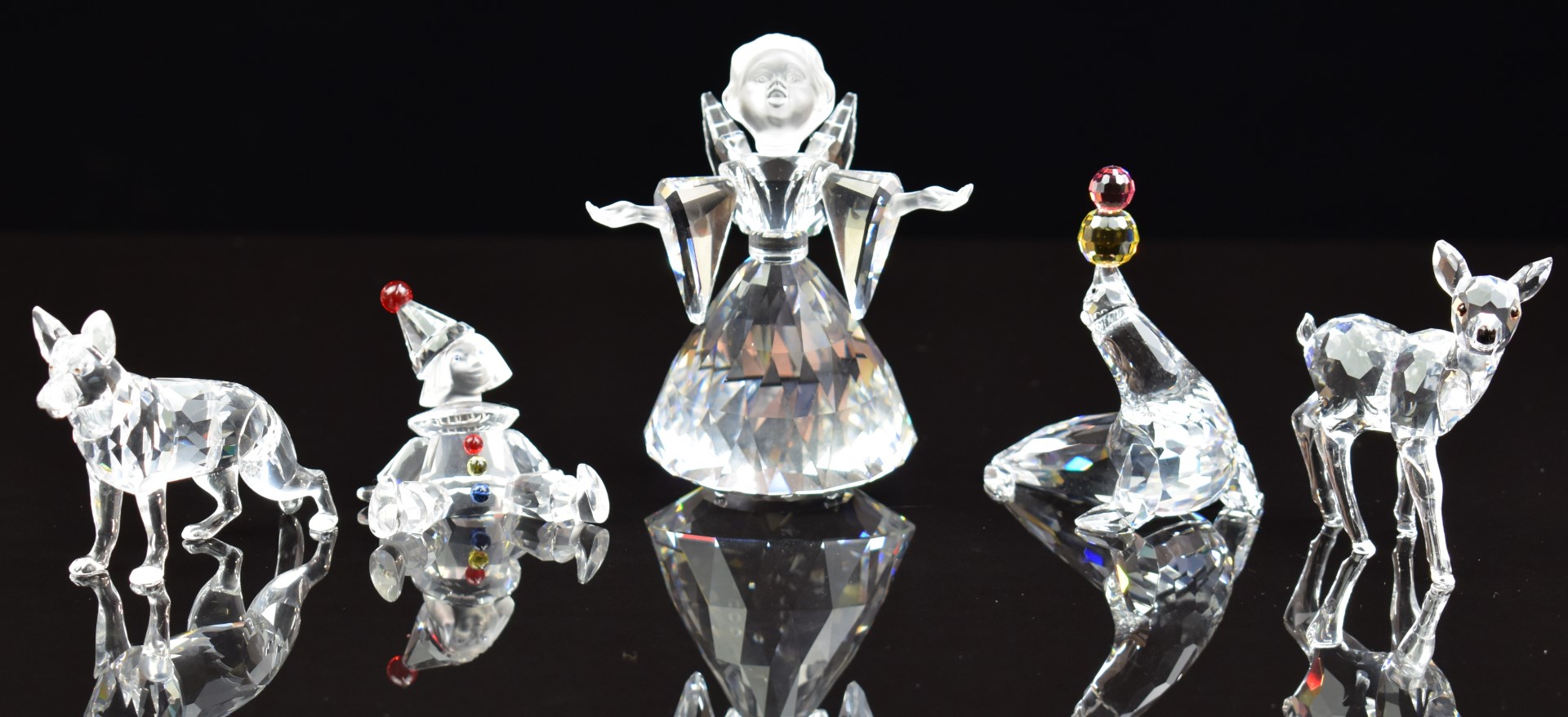 Five Swarovski Crystal cut glass figures and animals comprising angel, seal, clown, deer and