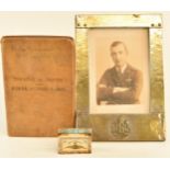 WW1 Royal Flying Corps matchbox cover, framed photograph of an RFC officer with cap badge attached