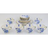 Nineteen pieces of bone china teaware with flower handles and Forget Me Not decoration