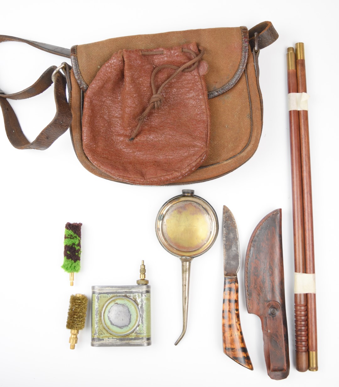 A collection of gun and shooting accessories including cartridge bag, cleaning kit, oil bottles etc.