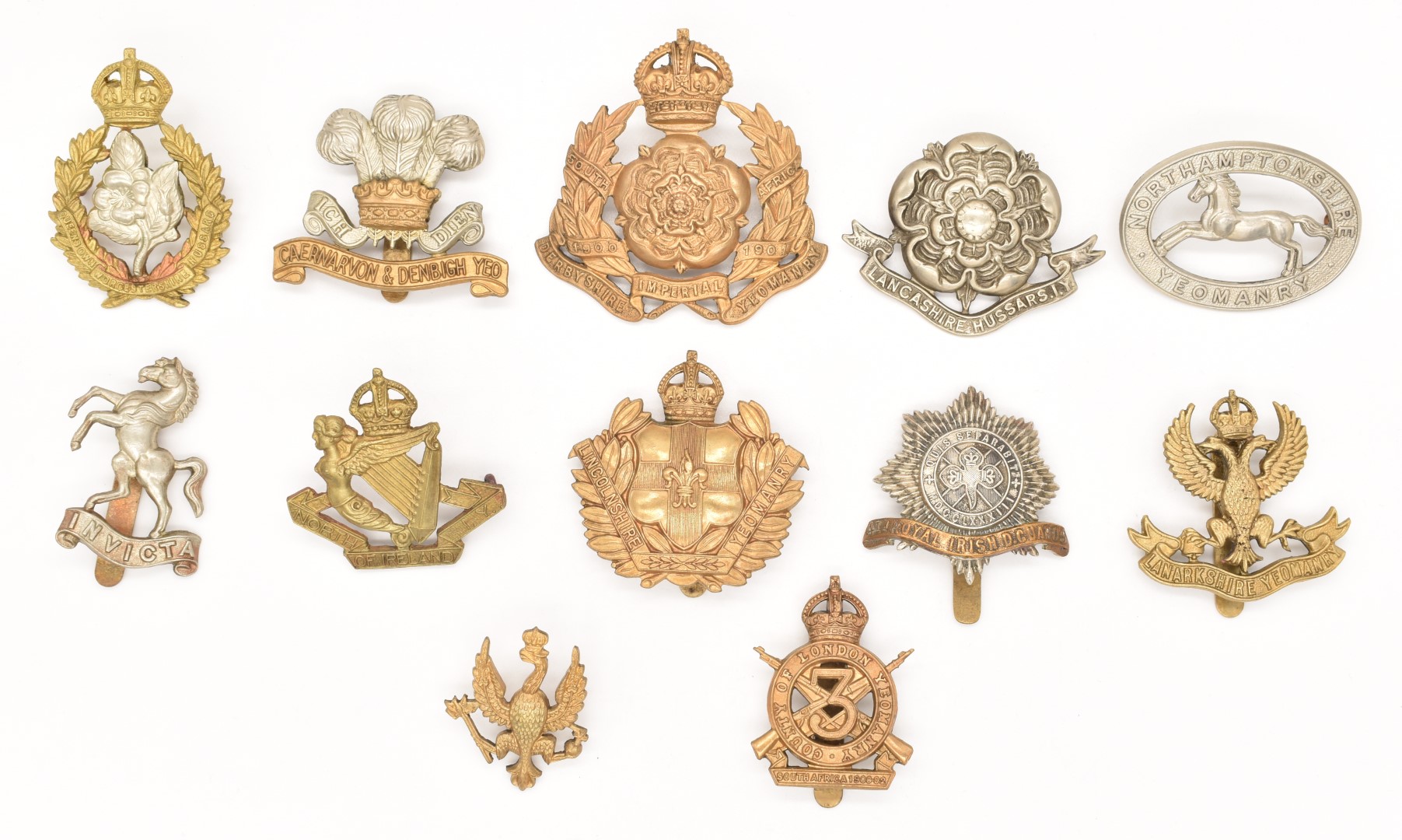 British Army 4th Royal Irish Dragoon Guards bi-metal cap badge and eleven metal Yeomanry badges