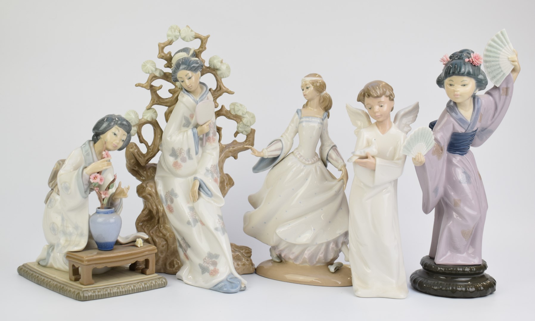 Four Lladro figurines comprising three Japanese and Cinderella, and a Nao angel, tallest 31cm