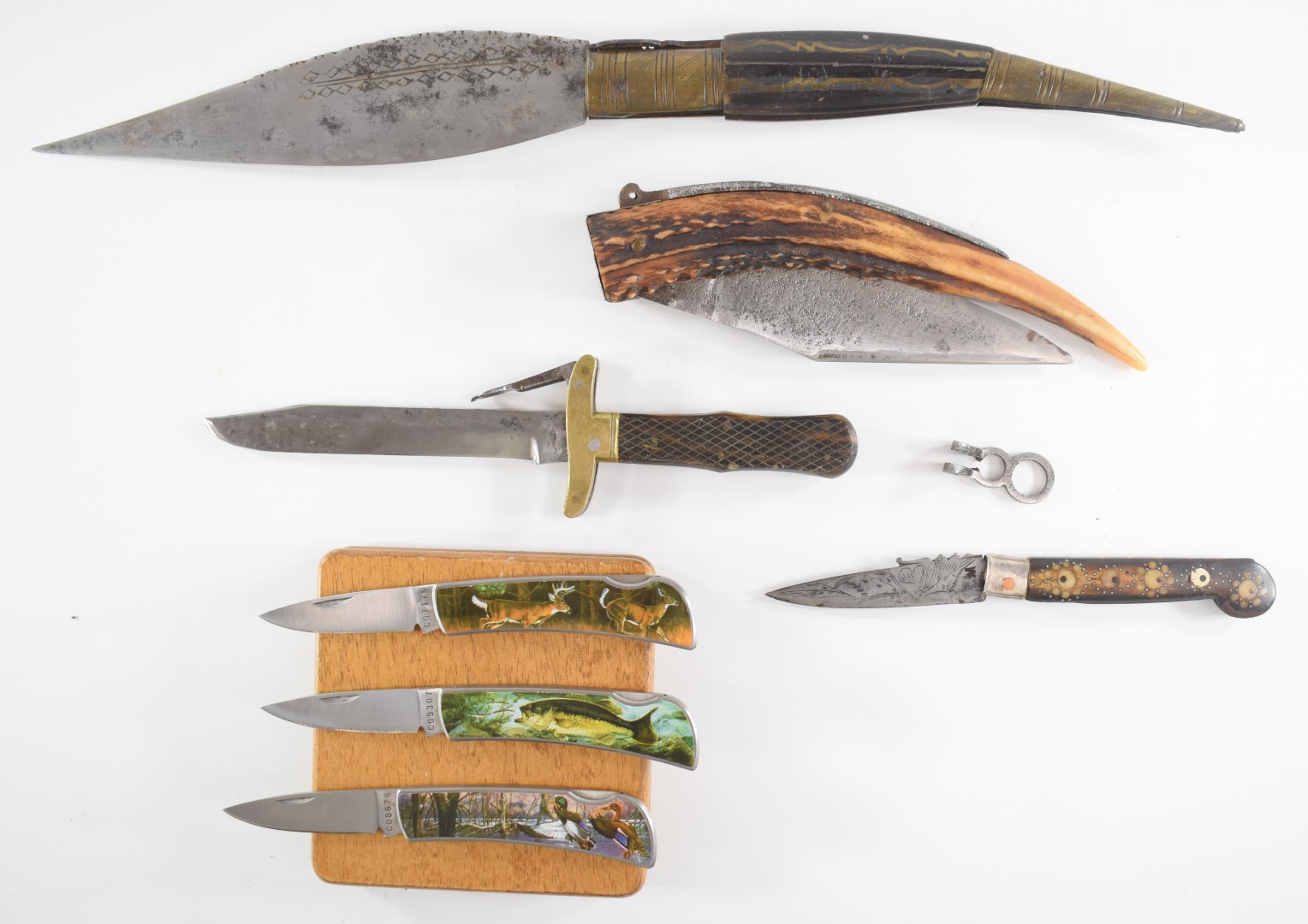 Seven various folding knives including two Middle Eastern examples and a cased set of three with