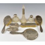 Hallmarked silver mounted items comprising hand mirror, three brushes, four silver topped dressing